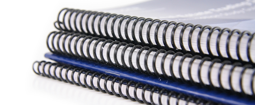 stack of training manuals that are ring-binded