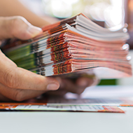 Business concept. Top view photo of workplace stack of pink diar